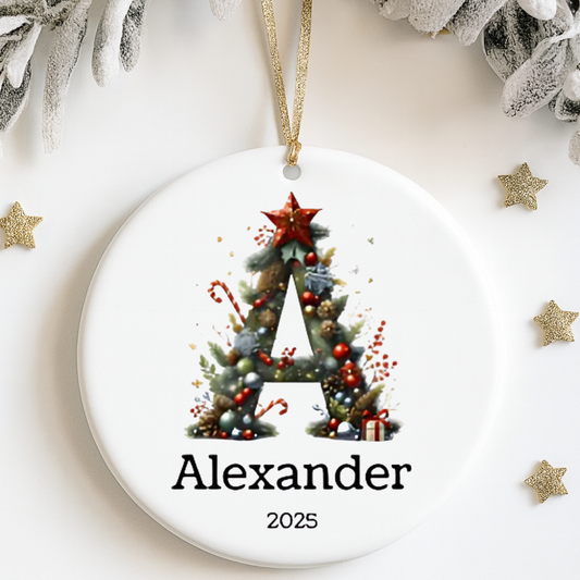 Round Christmas ornament with decorative letter 'A' and name 'Alexander' on a white background.